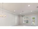Well-lit living area featuring wood floors, recessed lighting, and a door to the outside at 3402 Torre Blvd, New Smyrna Beach, FL 32168