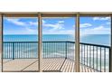 Ocean view from the balcony looking through the sliding glass doors with black railing in the foreground at 3425 S Atlantic Ave # 1602, Daytona Beach, FL 32118