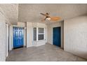 Entryway featuring tiled floor, textured walls, a window, 2 blue painted doors, and a ceiling fan at 3425 S Atlantic Ave # 1602, Daytona Beach, FL 32118