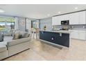 Open concept living area featuring a kitchen island, dining area and a comfortable living room at 460 Sarah Nicole Way, New Smyrna Beach, FL 32168