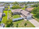 Spacious home features an attached two-car garage, nice front yard and a white fence at 5478 Landis Ave, Port Orange, FL 32127