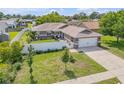 Lovely home showcasing a well-kept lawn, a two car garage, and a white fence at 5478 Landis Ave, Port Orange, FL 32127