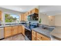 Efficient kitchen with light wood cabinets, stainless steel appliances, and ample counter space at 556 N Beach St, Ormond Beach, FL 32174