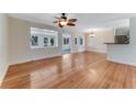 Bright, open living room with hardwood floors, connecting to dining and sunroom spaces at 556 N Beach St, Ormond Beach, FL 32174