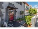 Inviting entrance featuring a stylish front door, lush garden, and cozy bench seating at 625 N Halifax Ave # 11, Daytona Beach, FL 32118