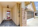 Inviting entryway featuring a brick column, cozy lighting, and a 'Welcome' doormat at 706 Fox Tail Ct, New Smyrna Beach, FL 32168