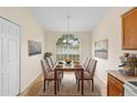 Elegant dining area with large window, neutral paint, and modern lighting at 910 Sheeler Oaks Dr, Apopka, FL 32703