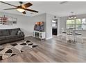 Bright and modern living room featuring gray walls, wood floors, ceiling fan, and contemporary furnishings at 920 Trafalgar St, Deltona, FL 32725