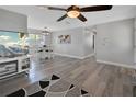 Bright open living room with wood floors, contemporary furnishings, and adjacent dining area at 920 Trafalgar St, Deltona, FL 32725