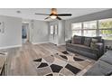 Comfortable living room featuring wood floors, a ceiling fan, and a neutral color palette at 920 Trafalgar St, Deltona, FL 32725