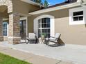 Inviting front porch with stone columns and comfortable seating area at 2600 Scottville Ave, Deltona, FL 32725