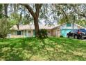 Inviting single-Gathering home with lush lawn, mature trees and charming curb appeal at 1010 Hanford Dr, Deltona, FL 32738