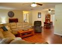Spacious living room with hardwood floors, ceiling fans, and comfortable seating area at 1010 Hanford Dr, Deltona, FL 32738