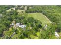 Vast property features rows of crops surrounded by green trees, with residential buildings tucked into the landscape at 1056 Reynolds Rd, De Leon Springs, FL 32130