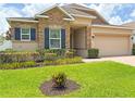 Charming single-story home with stone accents, dark shutters, and a lush green lawn at 110 No Name Key Dr, Deland, FL 32720