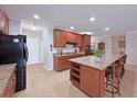 Bright kitchen with a center island, granite countertops, and modern appliances at 110 No Name Key Dr, Deland, FL 32720