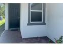 A close up image shows the front door of the house with gray trim and brick entryway at 112 Lost Ball Dr, Daytona Beach, FL 32124