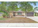 Inviting single-story home with a well-maintained yard and mature trees at 1204 Lawrence Ave, Deltona, FL 32725