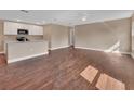 Open-concept living space with hardwood floors and a view into the kitchen area at 1226 North St, Daytona Beach, FL 32114