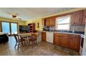 Bright kitchen featuring wood cabinets, tile flooring, and an adjacent dining area at 1301 Killian St, Daytona Beach, FL 32114