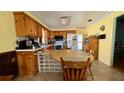 Cozy kitchen with wooden cabinetry, a breakfast nook, and modern appliances at 1301 Killian St, Daytona Beach, FL 32114