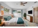 Cozy bedroom with a ceiling fan, windows for natural light, and stylish décor, a serene retreat at 1483 Meadowlark Dr, Deltona, FL 32725