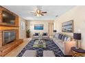 Comfortable living room featuring a brick fireplace, ceiling fan, and coordinated furnishings for relaxing ambiance at 1483 Meadowlark Dr, Deltona, FL 32725