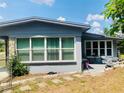 Exterior view showcasing a well-kept backyard patio with a table and chairs, great for outdoor enjoyment at 1485 Gainsville Dr, Deltona, FL 32725