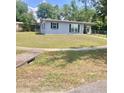 Quaint single-story home with a simple front yard and a walkway, ideal for a cozy living space at 1485 Gainsville Dr, Deltona, FL 32725