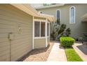 Close-up of condo exterior showcasing well-manicured landscaping, including a bay window at 15 Misners Trl, Ormond Beach, FL 32174