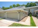 Charming condo with an attached garage and a walkway leading to the front entrance at 15 Misners Trl, Ormond Beach, FL 32174