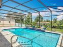 Sparkling pool with a screened enclosure, tile accents, and a gazebo in the background at 1520 Stone Trl, Enterprise, FL 32725