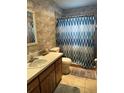 Bathroom featuring a shower with a patterned curtain and classic vanity at 15555 Sw 46Th Cir, Ocala, FL 34473