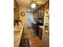 Functional kitchen with wood cabinetry, laminate countertops, and neutral flooring at 15555 Sw 46Th Cir, Ocala, FL 34473