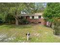 Charming brick two-story home with a well-maintained front yard and mature trees at 2032 Yorkshire Dr, Deland, FL 32724