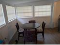 Cozy dining area with a dark wood table and four chairs, bathed in natural light at 20422 Canvas Back Rd, Altoona, FL 32702