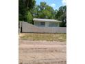 Quaint blue home surrounded by a white fence, offering privacy and curb appeal at 20422 Canvas Back Rd, Altoona, FL 32702
