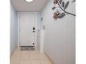 Bright entryway featuring decorative wall art, shoe cabinet, and tiled flooring at 2222 Ocean Shore Blvd # 304B, Ormond Beach, FL 32176