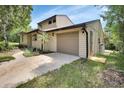 Charming two-story home featuring an attached garage and well-maintained lawn at 241 Bayou Vista St, Debary, FL 32713