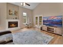 Cozy living room with vaulted ceilings, fireplace, and a view of the patio at 241 Bayou Vista St, Debary, FL 32713