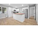 Bright kitchen featuring white cabinets, stainless steel appliances, and a butcher block island at 2434 Barbarossa Ave, Deltona, FL 32738