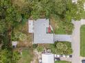 Birds-eye view of the property, showcasing the home's layout, roof, and surrounding trees at 2509 Kumquat Dr, Edgewater, FL 32141