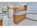 Bright kitchen featuring light wood cabinets, granite countertops, and a center island with a sink and storage at 2699 Audubon Ave, Deland, FL 32720