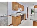 Functional kitchen showcasing an electric stove, ample cabinet space, and neutral countertops, with a view into an adjacent room at 2699 Audubon Ave, Deland, FL 32720