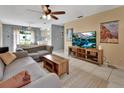 Cozy living room with tile flooring, ceiling fan, and comfortable seating for relaxing or entertaining at 272 Sunrise Blvd, Debary, FL 32713