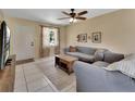 Comfortable living room with tile floors, ceiling fan, and view of the front yard through the window at 272 Sunrise Blvd, Debary, FL 32713