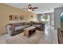 Inviting living room offering tile floors, ceiling fan, natural light and a view to the backyard at 272 Sunrise Blvd, Debary, FL 32713