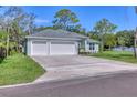 Inviting home with a three-car garage and a well-maintained lawn, offering ample parking and curb appeal at 2894 Hardy Ave, New Smyrna Beach, FL 32168