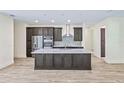 Modern kitchen features sleek countertops, stainless steel appliances, and a large island, perfect for culinary enthusiasts at 2894 Hardy Ave, New Smyrna Beach, FL 32168
