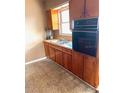 Traditional kitchen showcasing wood cabinets, oven, and double sink at 3 Cassia Ln, Debary, FL 32713